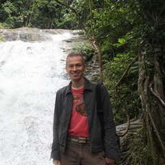 Dave in Red Teeshirt Smiling with Waterfall Background